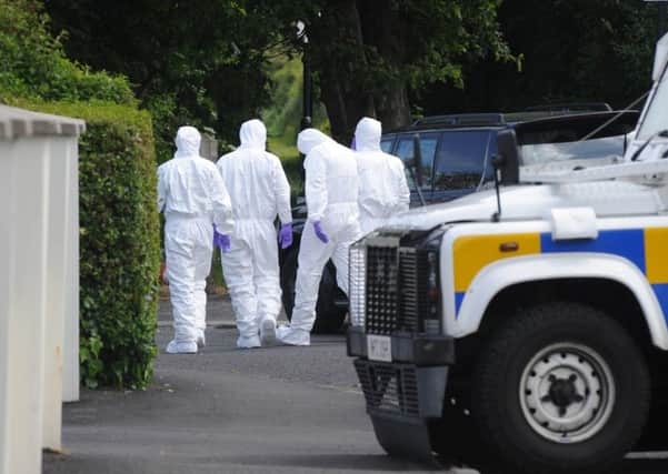 Forensic officers pictured arriving at the scene in Eglinton after the home of PSNI officers was targeted when a bomb was left under a car. DER2415MC055