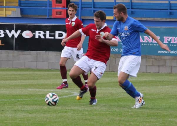 Glenavon's Ciaran Caldwell moves in to challenge for the ball against Chris Sergeant of TNS