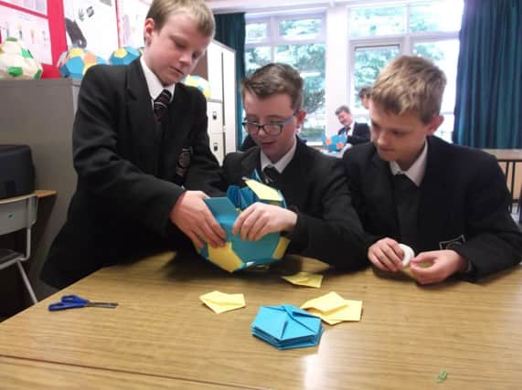 Cullybackey College pupils Jay McClean, Jonathan Logue and Aaron Halliday making a football from 2D shapes at the Year 8 Maths Fun Day. (Submitted Picture).