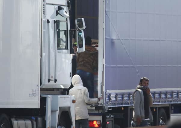 Migrants trying to board UK bound lorries on the main road into Calais ferry port. Photo credit: Philip Toscano/PA Wire