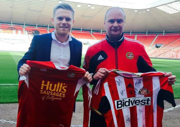 Sunderland AFCs Foundation of Light Brett McGoldrick and David McComb of Carniny Youth FC after securing the clubs' partnership.