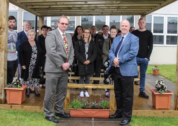 Principal Nigel Pell-Ilderton and vice principal Raymond Leeman with staff, governors and family and friends of former pupils and teachers at the official opening of the memorial garden at Monkstown Community School. INNT 26-515-SO