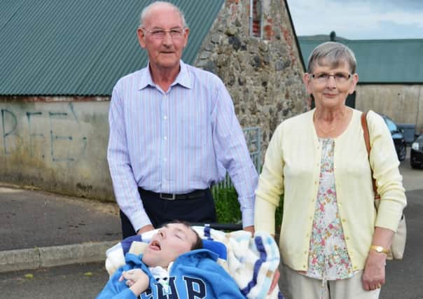 Stephen McLenaghan pictured with his dad Raymond and mum Amber.