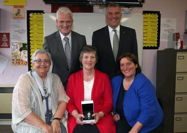 Barbara McCord (centre), who retired as a Maths teachers from Ballymena Academy, is pictured receiving gifts from Karen Johnston (Vice-chair Board of Governors), Jane Allen (secretary Board of Governors), James McKerville (Chair Board of Governors) and Stephen Black (Principal). Barbara has had a 51 year association with the school, both as student and teacher. INBT28-202AC