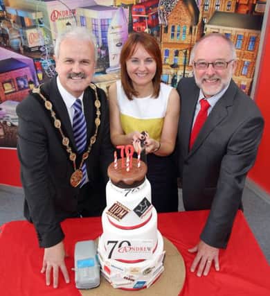 Mayor Thomas Beckett helps Mairead and Tim Andrew cut a cake to mark the 70th anniversary of Lisburn based Andrew Ingredients, supplying the food and baking industries with top quality ingredients. US1524-502cd  Picture: Cliff Donaldson