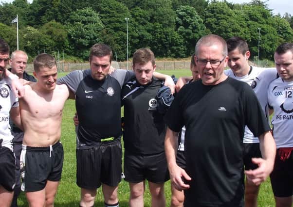 New St. Peter's manager Mickey Devlin with his players after the win over Culloville.