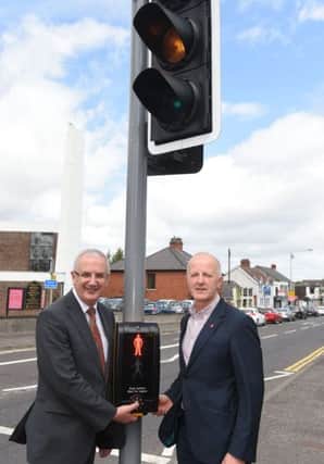 Transport Minister Danny Kennedy (Left) with TransportNI Engineer Roy Gordon switching on the new PUFFIN Crossing at Finaghy. Photo by MT Hurson/Harrison Photography