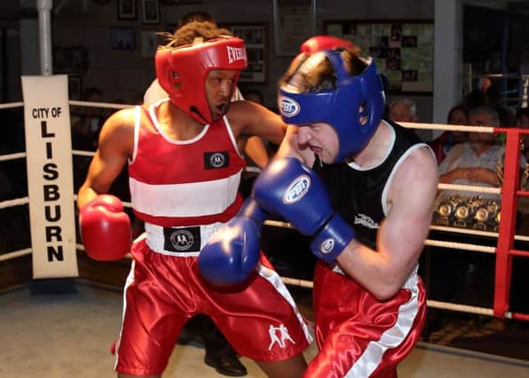 Mosa Kambule (red) from Lisburn Boxing Club takes on G McKeown (blue) from Sacred Heart, at Lisburn Boxing Club's Friday Fight Night. US1525-513cd  Picture: Cliff Donaldson