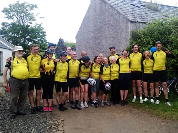 Isabel Woods welcome family and friends who recreated her 386 mile cycle journey from Mizen Head at the finish line in Fair Head. INLT-28-700-con