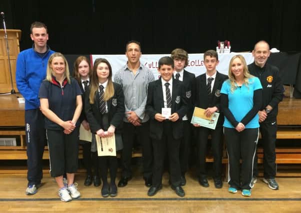Special guest, former MMA fighter Rodney Moore, pictured with prizewinners at Cullybackey College's Sports Awards Assembly. Included are school PE staff Mr J Kelso, Mr R Cowan, Mrs G Hall and Mrs J Robinson.