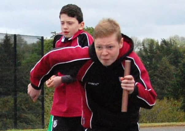 Determination shows on the face of Cameron Mark during the Year 9 relay race at Cullybackey College sports day.
