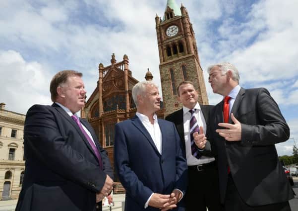 Enterprise, Trade and Investment minister Jonathan Bell MLA, right, chatting to Bill Thomas, second from left, of One Source Virtual, at the jobs announcement in the Guildhall on Thursday. Included are Bill Scott, left, and Derek Andrews, of Invest NI. DER2715-108KM