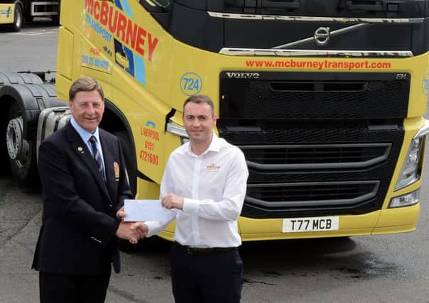 Ballymena Golf Club captain, Henry Eagleson, is pictured receiving sponsorship for the club's annual open week from Philip McBurney, of McBurney Transport. INBT28-220AC