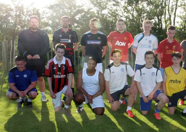 UNITED. Ballymoney Utd Manager, Peter Cairns along with players at a training session on Thursday night.INBM28-15 109SC.