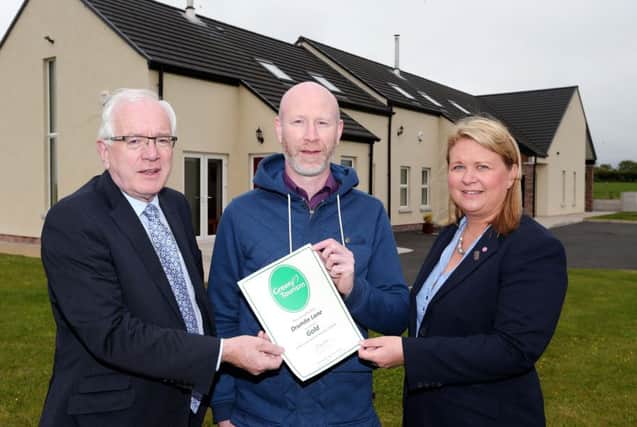 Pictured at Drumlin Lane Cottages, Hillsborough which were recently accredited with a Gold Award in Green Tourism are: (l-r) Alderman Allan Ewart, Chairman of the Council's Development Committee;  Glenn Harvey, Proprieter; and Elaine Lappin, Visitor Information Centre Supervisor.