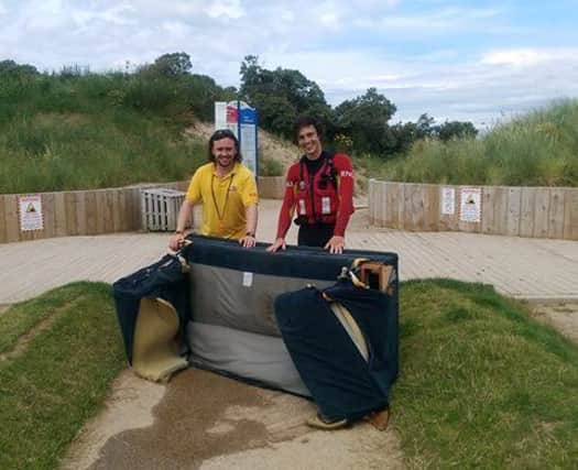 Sofa, so good: Senior lifeguard Bosco McAuley and lifeguard Bruce Traill pictured with the sofa they recovered from the sea at Whiterocks Beach in Portrush.