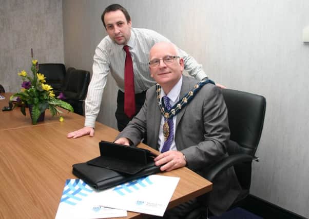 Mid and East Antrim Borough Council Mayor, Billy Ashe is pictured here being shown how to make an online application for the Good Relations Grants Scheme by James Healy, Grants Officer.