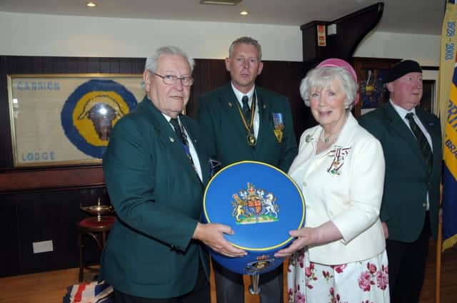 Alan Hamilton, chairman of the Carrick Branch of Royal British Legion, presents the Lord Lieutenant for County Antrim, Joan Christie OBE with a gift of a footstool, which was made by Stephen Weir. INCT 26-230-AM