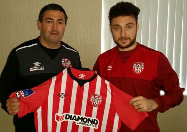 Derry City manager Peter Hutton pictured with new signing Mark Quigley.
