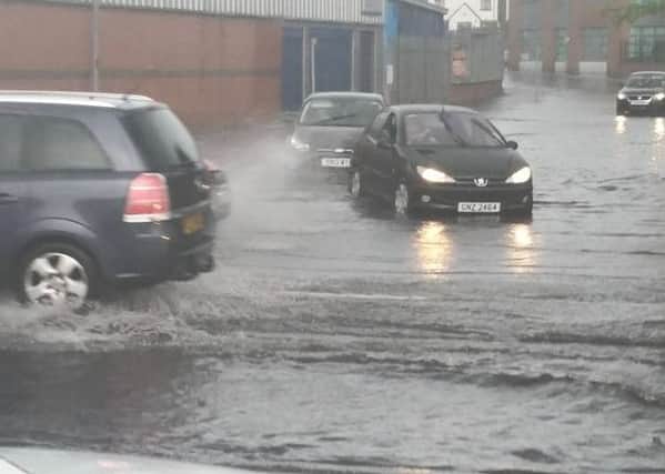 Motorists brave the flood water as they drive froom Duncreggan Road onto Strand Road last night. Photo: Pamela Mullan