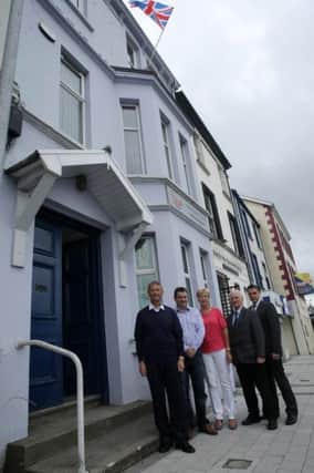 FLAGS AND EMBLEMS. . . .DUP officers, Ald. Maurice Devenney, Ald. David Ramsey, Ald. Hilary McClintock, Ald. Drew Thompson and Ald. Grahame Warke pictured outside the DUP offices at Ebrington Terrace yesterday afternoon. INLS2715MC002