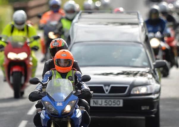 Pacemaker Press 7/7/2015
Dr Fred MacSorley and Dr John's Partner (Janet) leads the Cortege , As Motorcyclists pay tribute to the late road racing doctor John Hinds on Tuesday by riding with his cortege during a lap of the Tandragee 100 course, Which was his favourite  road racing circuit  . The well-known 'flying doctor' died on Saturday following a crash during a practice session at the Skerries 100 in the Republic of Ireland.  Dr Hinds was a intensive care consultant and anaesthetist at Craigavon Hospital in Co Armagh but frequently attended road races to provide medical cover.
Pic Colm Lenaghan/Pacemaker