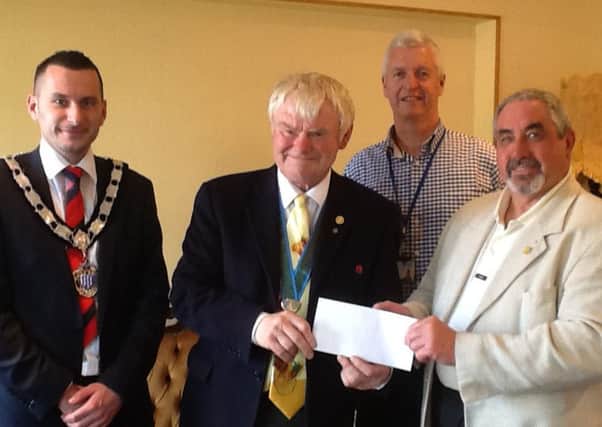 Ian Bates, right, is congratulated by Mid and East Antrim Boroughs deputy mayor, Councillor Timothy Gaston as he receives his £50 shopping voucher.Making the presentation  is John Shannon, chairman of Larne Traders Forum and Mid and East Antrim Boroughs Ossie Porter, who issued the lucky ballot. INLT 29-650-CON