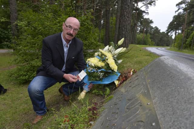 Liam Beckett close friend of the Dunlop family pictured leaving flowers on behalf of May Dunlop and family at the place  where multi World champion and recently voted Northern Irelands greatest ever sportsman Joey Dunlop tragically lost his life fifteen years ago in Tallinn Estonia.

Picture by  Stephen Hamilton / Presseye
