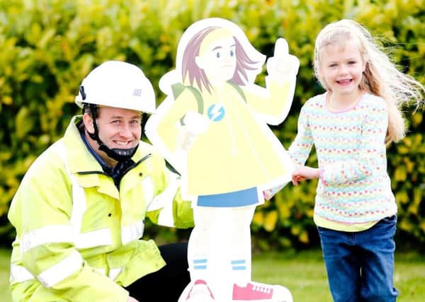 NIE safety engineer Hal Steele with Caitlin Spence and safety superhero Suzy Sparkz at the launch of NIEs latest summer safety campaign.  INCT 28-731-CON