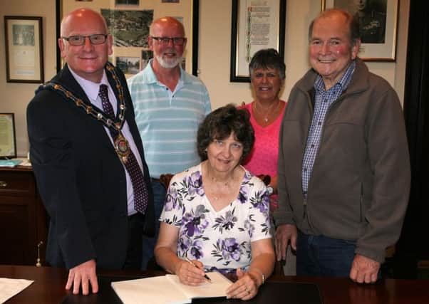 Linda and Peter Radmanovich, from Cape Town in South Africa, are pictured signing the visitors book at The Braid, during their reception with the Mayor of Mid and East Antrim, Cllr. Billy Ashe. Linda and Peter are over visiting friends Glynnis and Liam Getty. Linda and Glynnis have been pen pals for 50 years and this is the first time they have met. INBT28-250AC