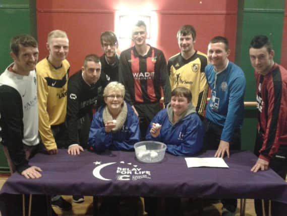 Representatives from the eight clubs at the Banbridge District Cup draw with Marjorie Dale and Kim Brown from Cancer Research UK.