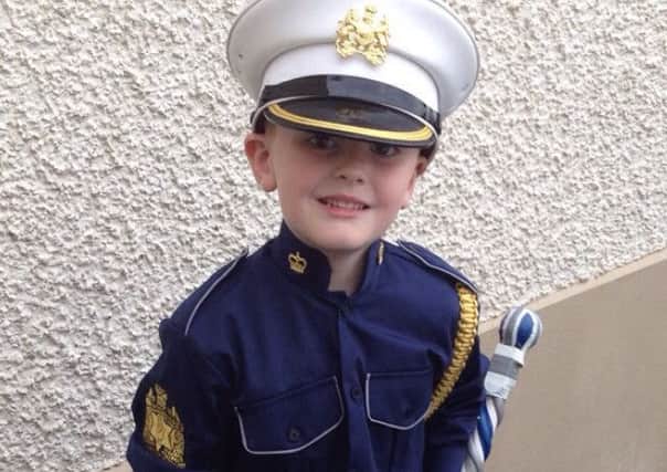 The youngest Glenhugh member, Rhys Kyle, wearing the band's new uniform