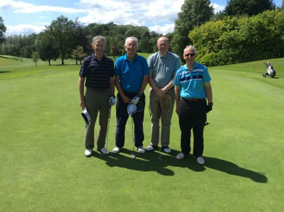 Dunmurry golfers Peter Reville, George Summers, Walter Gibson and Brendan O'Reilly on the 18th green after a hard day's golf.