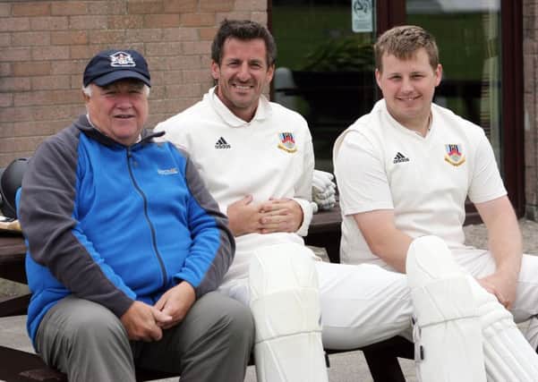 Harry Cowden chats with Ballymena batsmen James Kennedy and William Montgomery. INBT30-233AC