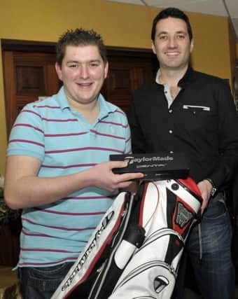 Conor Mulholland (left) who finished second in the Open, receives an earlier prize from club pro Jason Greenaway.