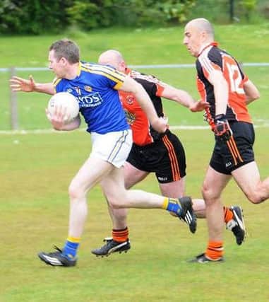St Joseph's Glenavy players attempt to tackle an opposition player during a recent match.