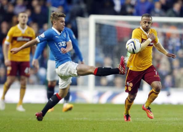 Rangers' Andy Murdoch (left) and Motherwell's Lionel Ainsworth battle for the ball during the Scottish Premiership Play Off Final, first leg match at Ibrox. Photo credit: Danny Lawson/PA Wire.