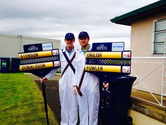 Peter and Andrew Morgan after carrying the score-boards on Sunday at the Open Championship at St Andrew's.