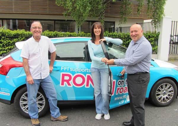The journey begins as Steve Jacques, CEO of Key Assets International hands over the wrapped support car donated by Fostering First Ireland (FFI) to foster carers Ron and Carol Cummins. Pictured (l-r) Ron, Carol and Steve Jacques.  INLT 30-687-CON