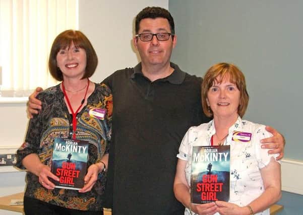 Author Adrian McKinty with Carrickfergus Library branch managers Joan Douglas and Dawn Young.  INCT 30-720-CON