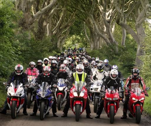 KEEP'ER BETWEEN THE HEDGES.  Joe O'Kane (centre) pictured at the Dark Hedges along with some of the 80-90 riders who took part in the AMRRC Road Run on Sunday.INBM30-15 048SC.