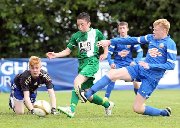 Foyle Harps' Corey McBride and Glenavon's Jack McIvor in action in the Hughes Insurance Foyle Cup. Picture by Lorcan Doherty