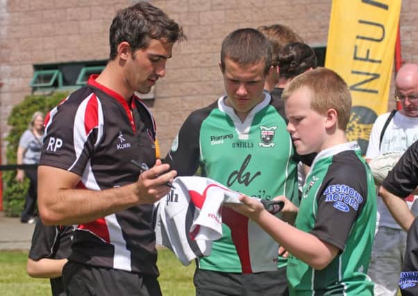 Ulster rugby star Ruan Pienaar signs a jersey for a young City of Derry during a visit to Judges Road last year and there will be another chance to receive some coaching from Ulster players this week at the City of Derry summer camp which starts on Monday.