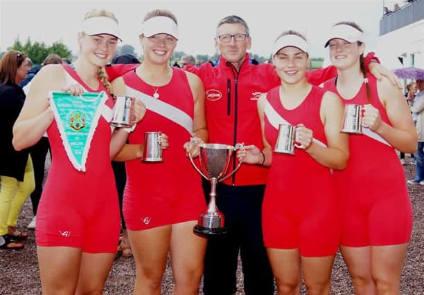 Rebecca Meenagh, Erin Barry, Katie Shirlow and Hannah Scott, with coach Geoff Bones, gold medal winners in the ladies four.