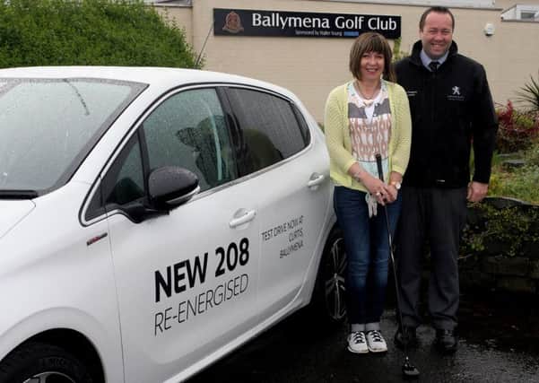 Damien O'Kane, of Curtis Peugeot, who sponsored a recent competition at Ballymena Golf Club, with club representative Elaine Mark. INBT31-200AC