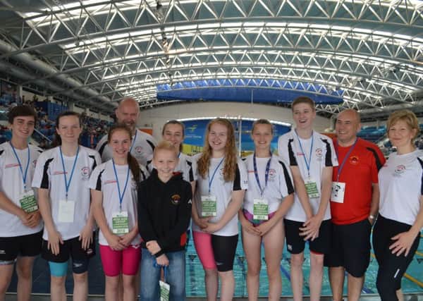 Some of the Banbridge Swim Team, L to R:William, Kate, Julia, Coach Graham Knox, Ruby, mascot Adam, Maeve, Becki, Ross, Chairman Mark Wilson and Coach Fiona Cleland pictured at the Irish Age Group Championships and Summer Open meet.