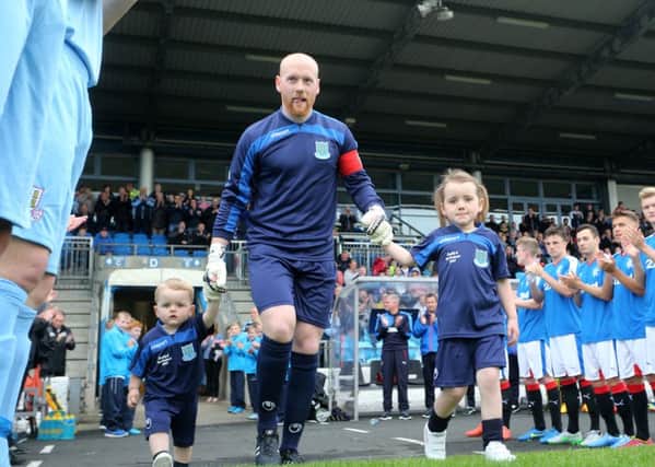 Dwayne Nelson is applauded onto the picth as he takes to the field with daughter Sophie and son Jacob before last week's testimonial match against a Rangers XI.