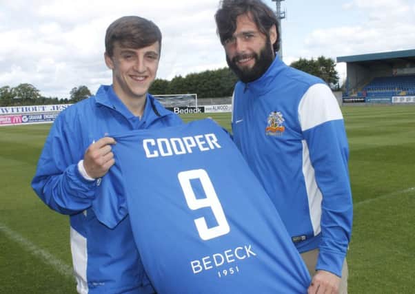 New signing Joel Cooper gets the number 9 shirt from Glenavon manager Gary Hamilton.