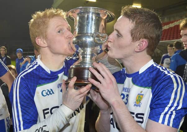 Ballinderry's Coilin and Aaron Devlin celebrate with the Ulster Club trophy.