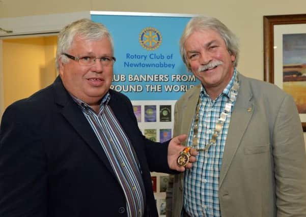 Gavin Millar (left), outgoing president of the Rotary Club of Newtownabbey, hands over the chain of office to new president, Leonard Sproule. INNT 27-003-PSB
